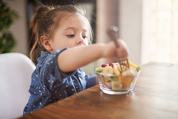 young child eating fruit