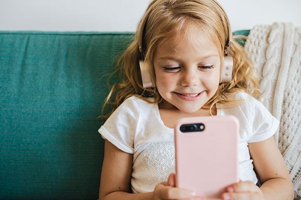 Little girl watching cartoons on her phone