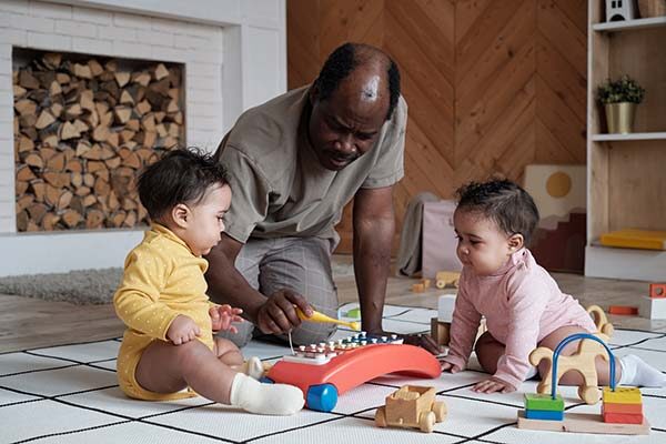 father playing with daughters