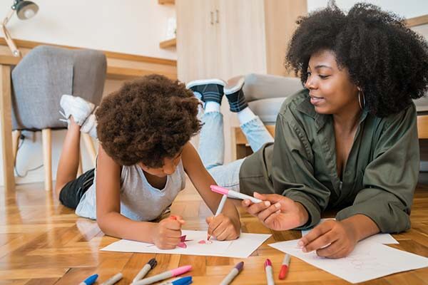 woman drawing with girl