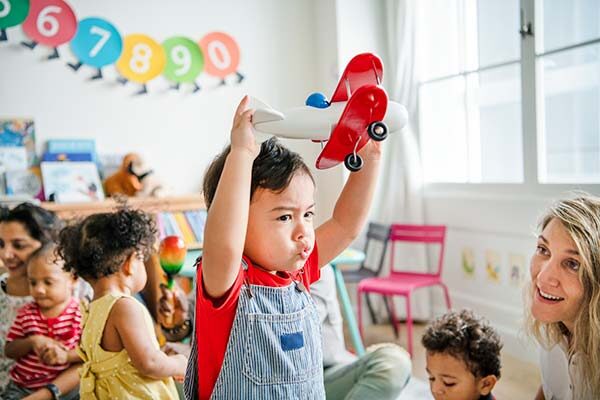 preschooler enjoying playing with an airplane